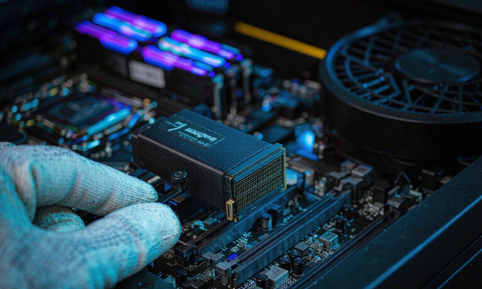 Philips M.2 NVMe SSD placed on motherboard by technician, manufactured by OV CHIP TECH